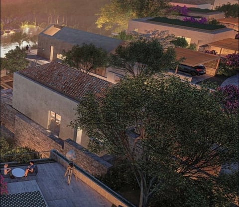 Aerial view of modern house with green roofing surrounded by trees, illuminated during dusk in a residential area.